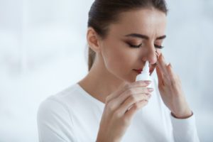 cold beautiful woman using nasal spray picture id 300x200