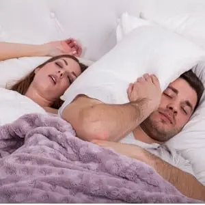 man with pillow on head in bed picture id