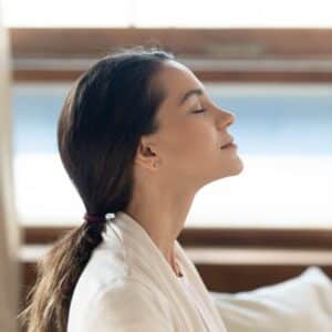 pretty young girl sitting on sofa indoors relishing beautiful morning picture id 300x300