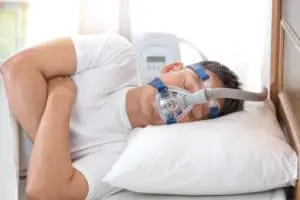 senior man wearing Cpap mask sleeping 300x200